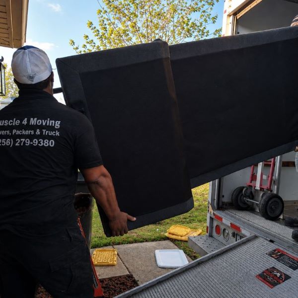 A heavy adjustable bed being delivered to a home in a neighborhood near Sparkman High School by the Muscle 4 Moving crew, providing specialty moving services in Harvest, AL.