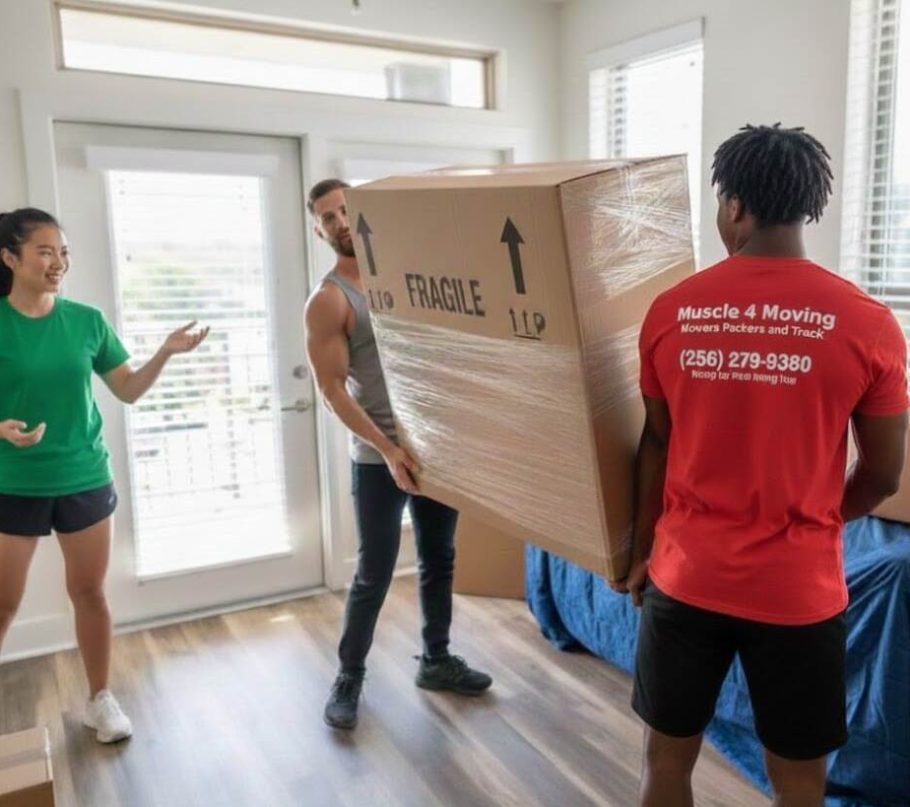 Household movers carrying a large boxed item in a home while the resident look on.